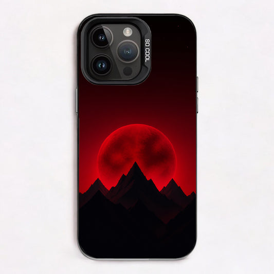 Silhouetted mountain peaks with a glowing red moon in the background, scattered stars above, dark tones overall.