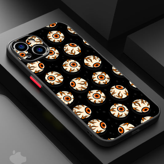 Repeating pattern of cartoonish eyes with orange and black accents on a black background.