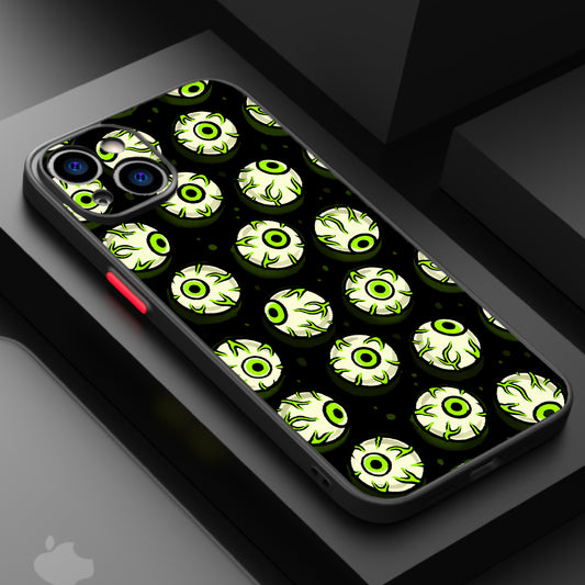 Repeating pattern of cartoonish, glowing green eyes with black pupils on a dark background.