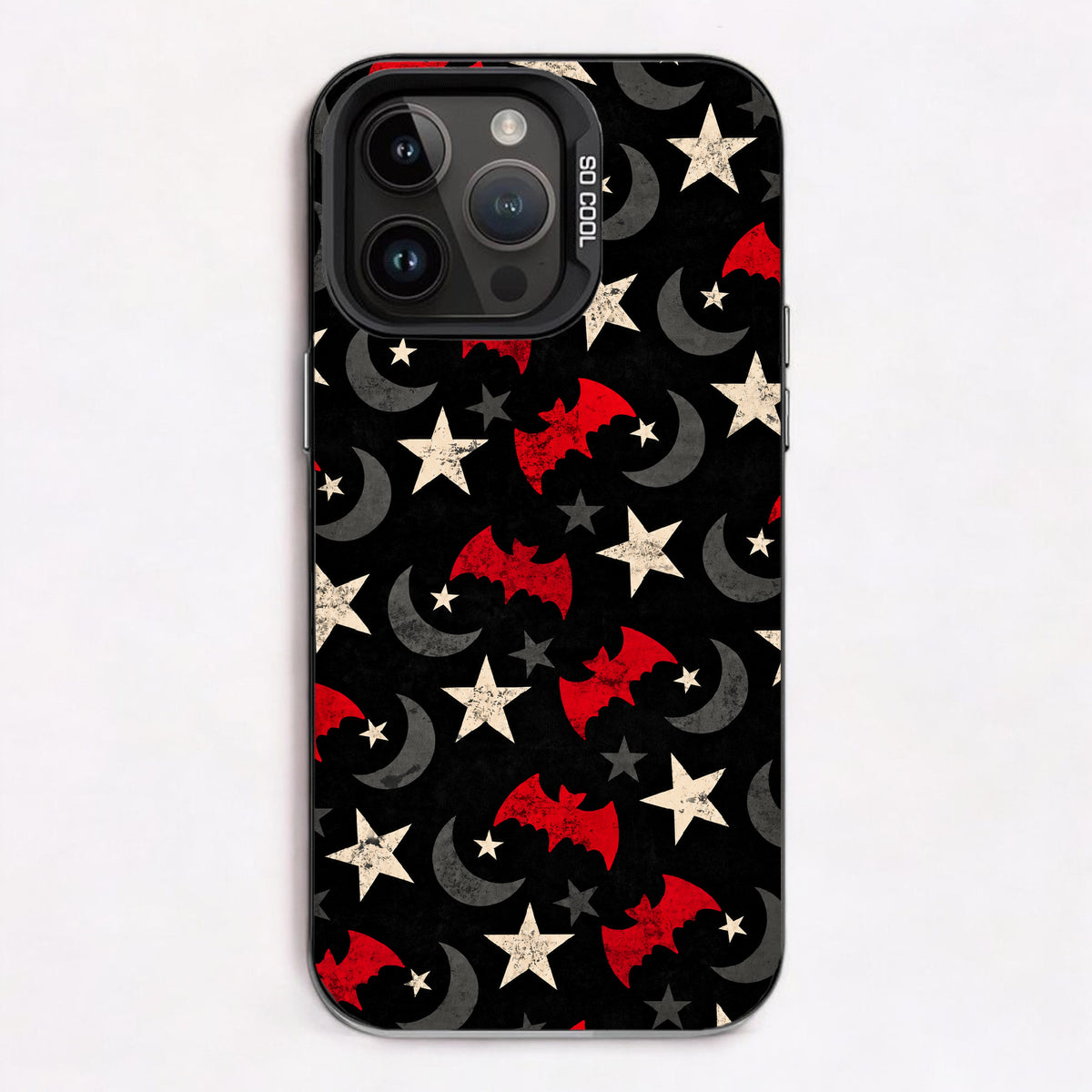 A repeating pattern of red bats, gray crescent moons, and white stars on a black background.
