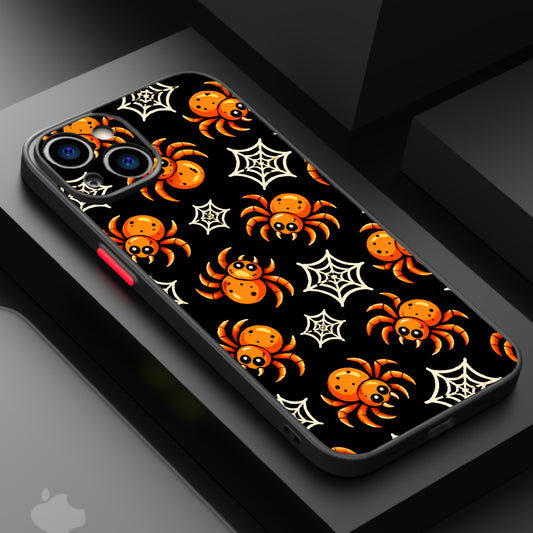 A black background with orange spiders and white spider webs, creating a spooky and playful Halloween theme.