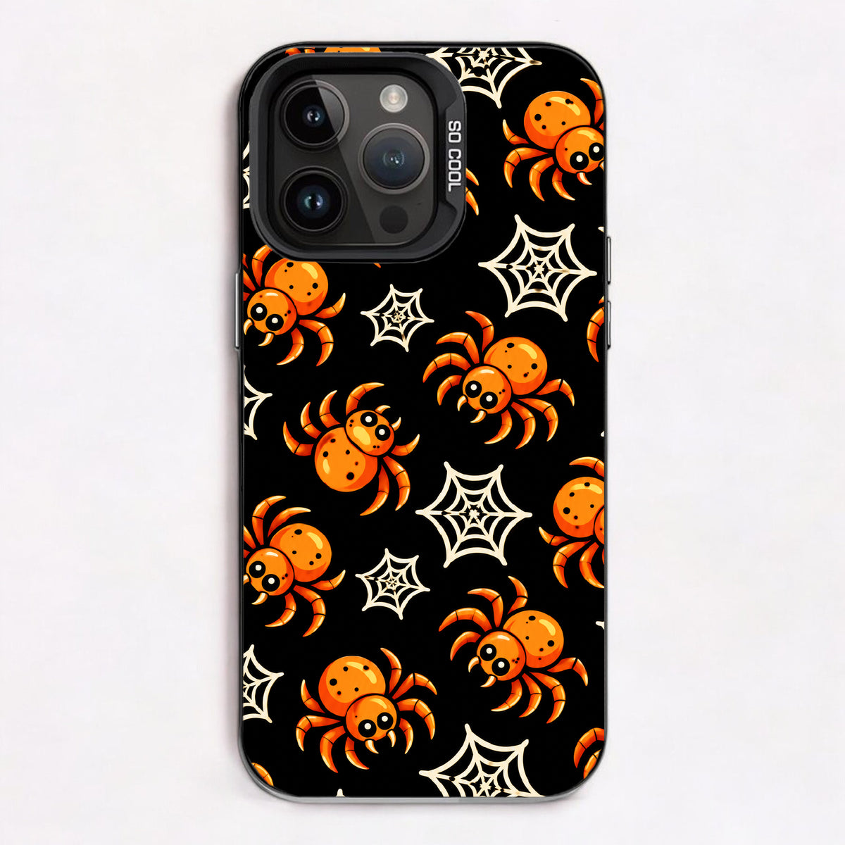 A black background with orange spiders and white spider webs, creating a spooky and playful Halloween theme.